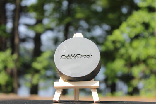 A handmade bar of soap that is black and in the shape of a hockey puck. Give Yer Balls a Scrub smells like men's cologne and was made from 100% organic oils.