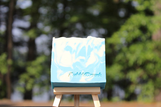 A handmade bar of soap that is swirled blue and white with crisp linen and fresh cotton fragrances. Smells Like Clean Spirit was made from 100% organic oils.