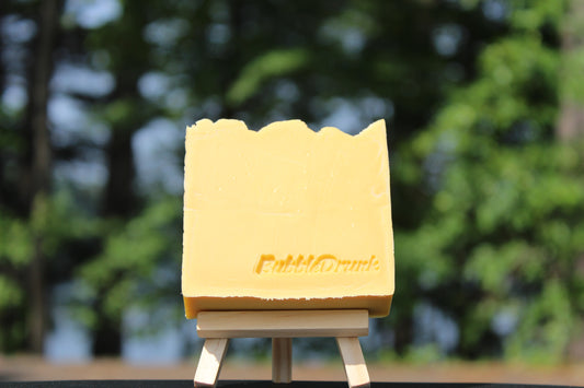 A handmade bar of soap that is yellow gold in color and scented with Fresh Squeezed Orange Juice and Champagne fragrances. Three Mimosa Brunch was made from 100% organic oils.