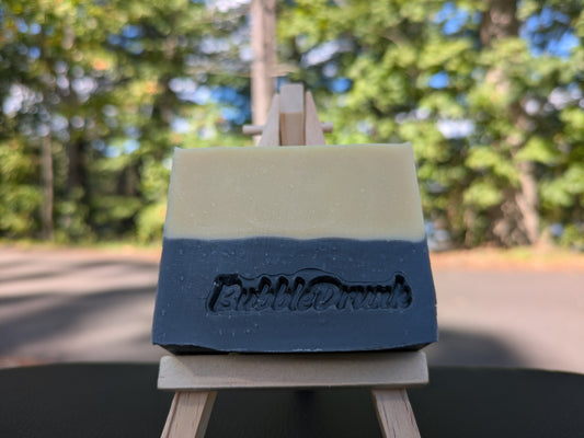 A handmade bar of soap that is tan and black, and scented like a men's cologne. Buzzed Bee was made from 100% organic oils.