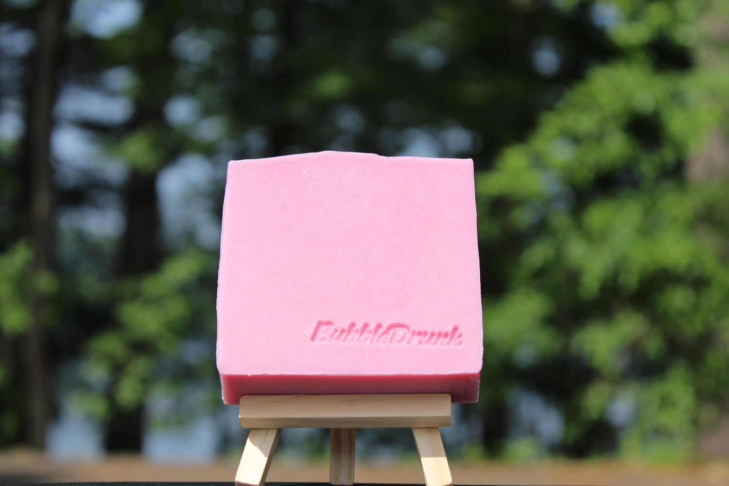 A handmade pink bar of soap that is scented with Champagne fragrance. BubbleDrunk was made from 100% organic oils.